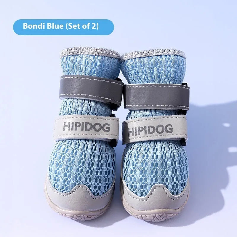 Pair of light blue cartoon-style dog shoes on a white background.