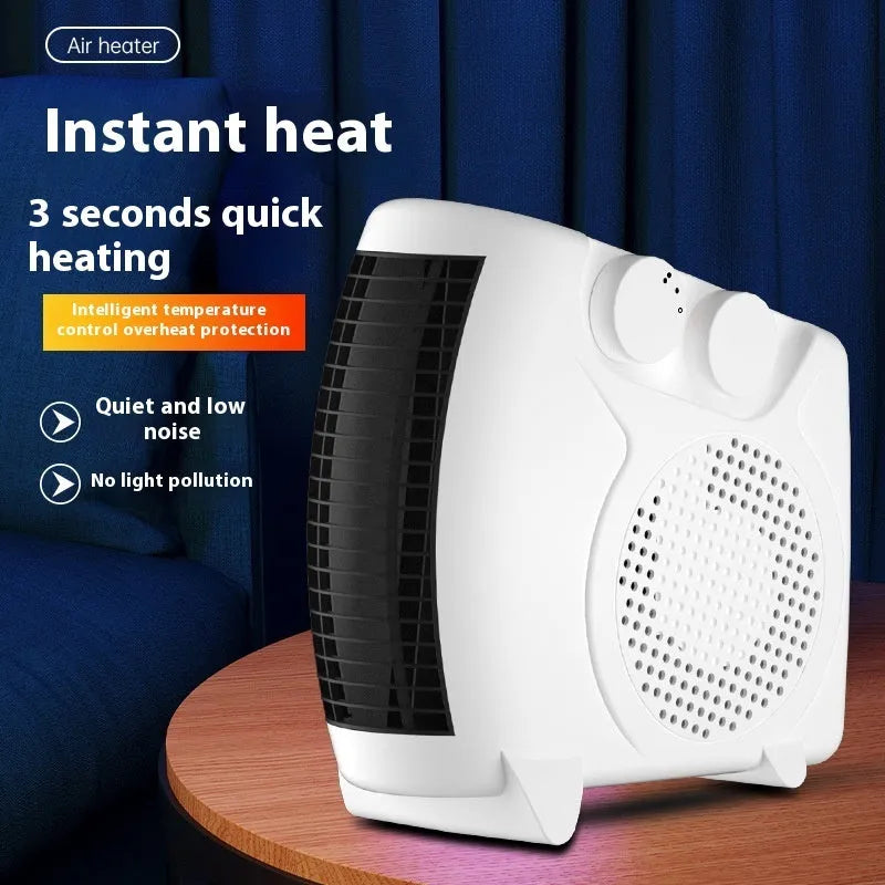 White compact electric fan heater on a desk, showing control dials and air outlet grille.
