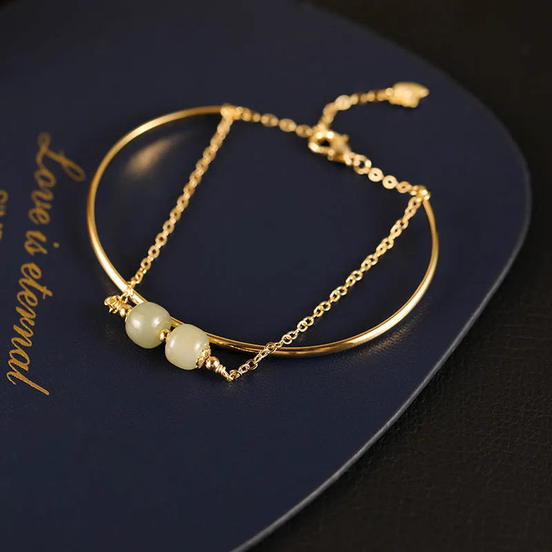Hetian jade lucky beads bracelet with gold inlay, shown in women's fake two pieces style.