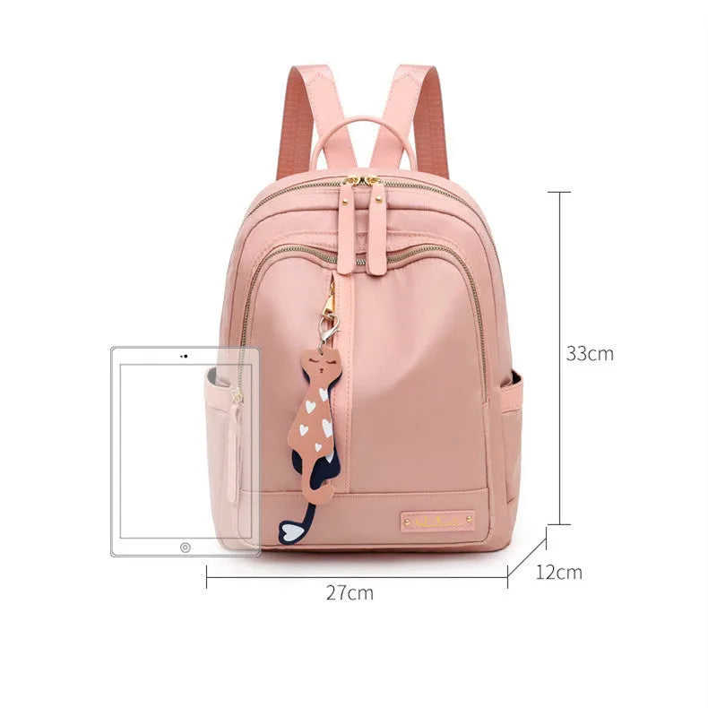 Black women's casual nylon backpack with soft handle and shoulder straps showing internal compartments