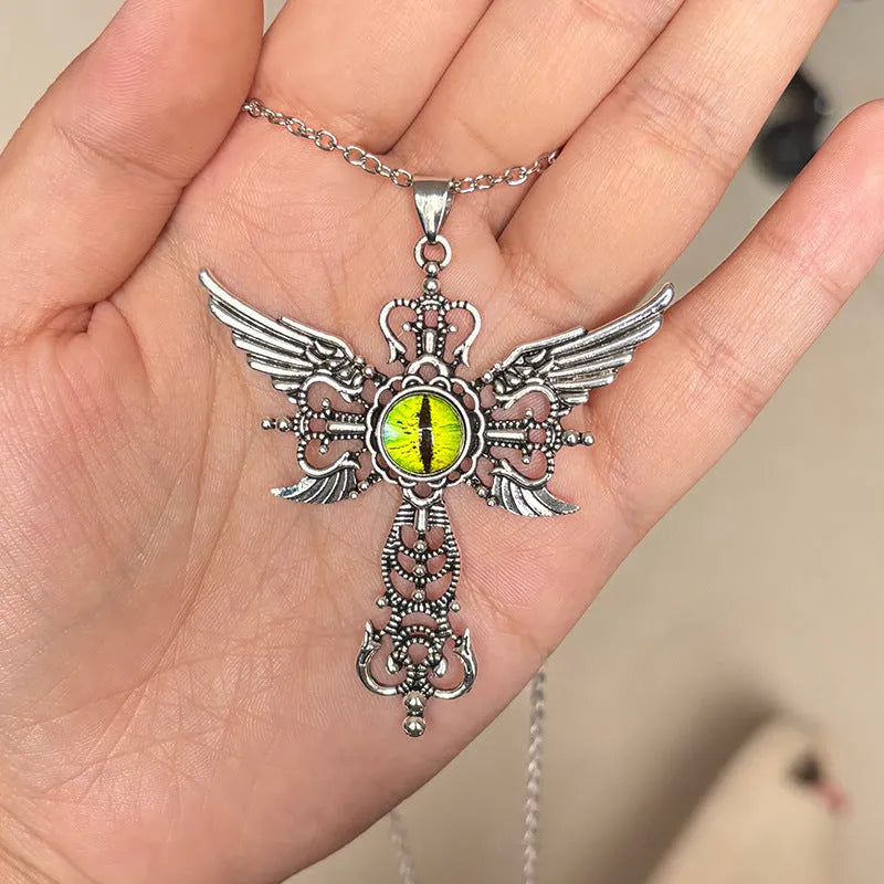 Close-up of a blue alloy necklace featuring a geometric cross pendant with detailed devil wings.