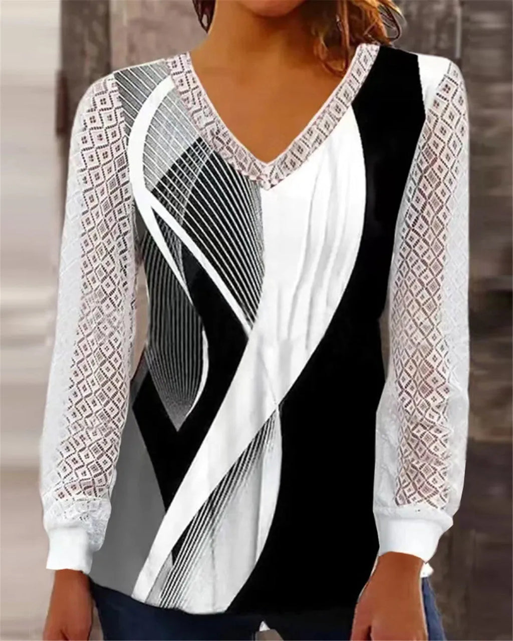 Women's loose purple V-neck pullover top with lace print and long sleeves on a hanger.