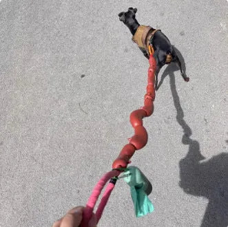 Brown three-section sausage rope toy 108cm long held by hand, pet tug and fetch rope