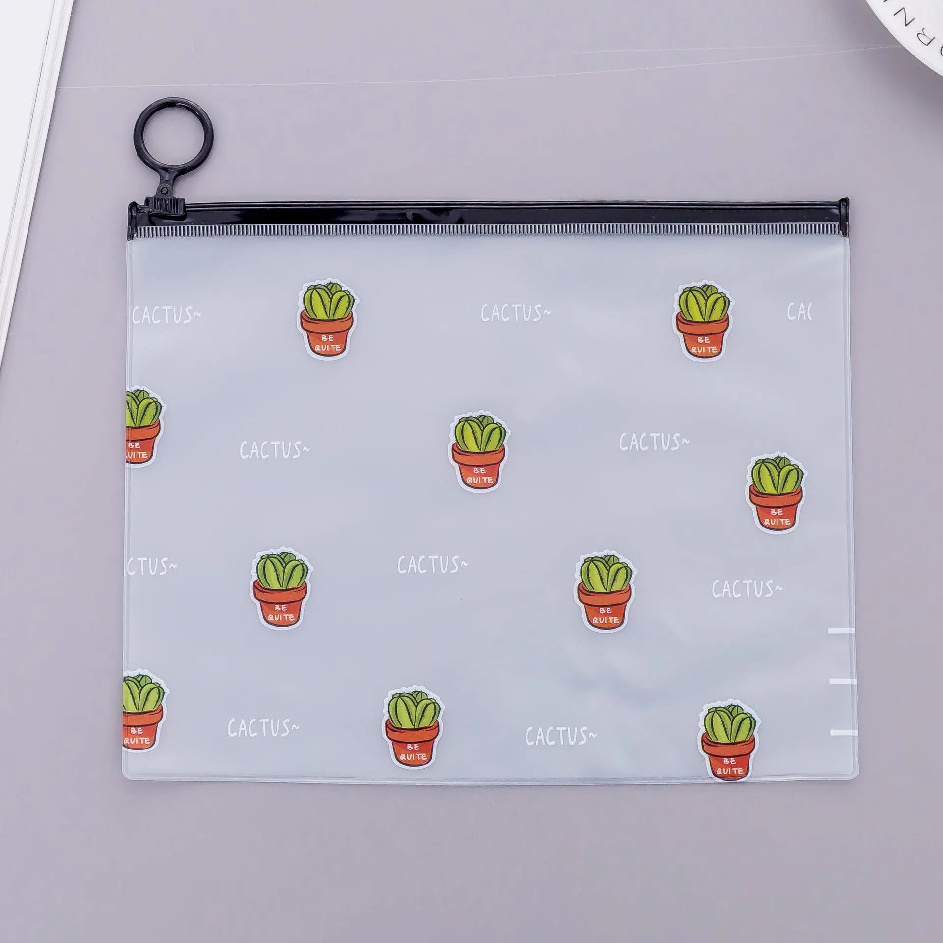 PVC pencil case with sealed closure, cactus print, 17.1x21.2cm, on a desk with stationery