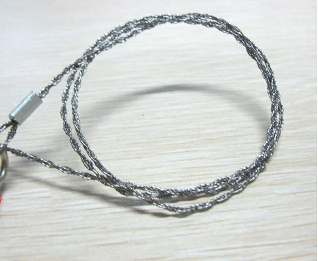 Stainless steel survival wire saw with thumb rings showing 55cm blade and compact storage size