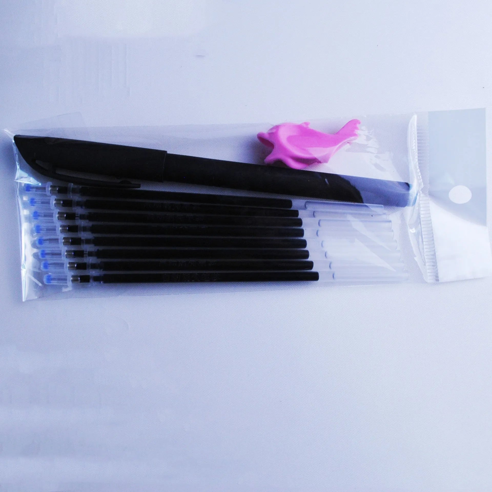 Blue automatic fading pen set with 0.5mm tip, eight refills, and plastic holder on white background