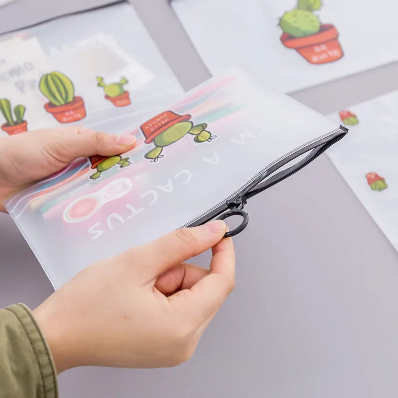 PVC pencil case with sealed closure, cactus print, 17.1x21.2cm, on a desk with stationery