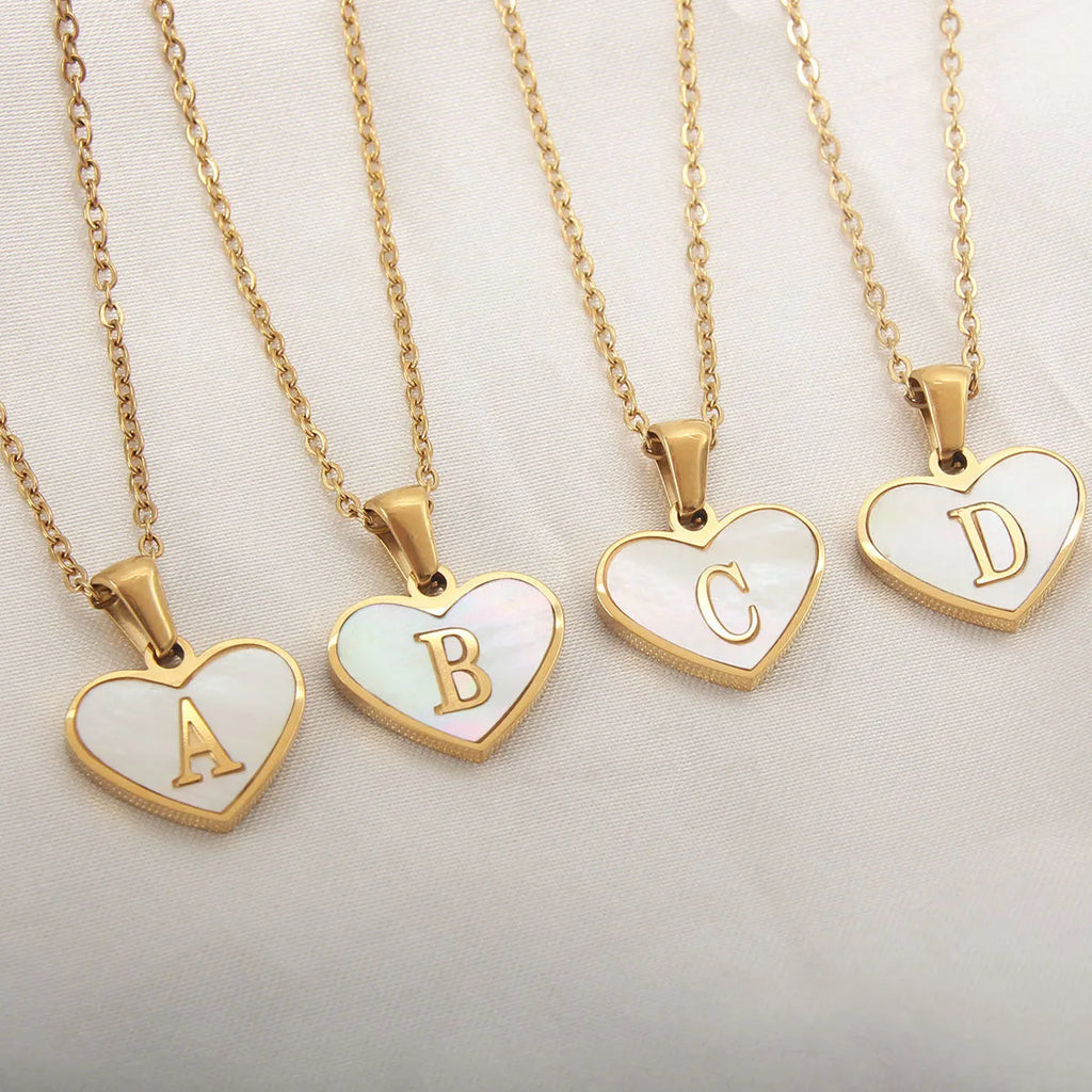 Gold heart necklace with white shell centre on stainless steel chain