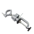 Small flat 360-degree rotating clamp-on bench vise made of tungsten steel on a workbench