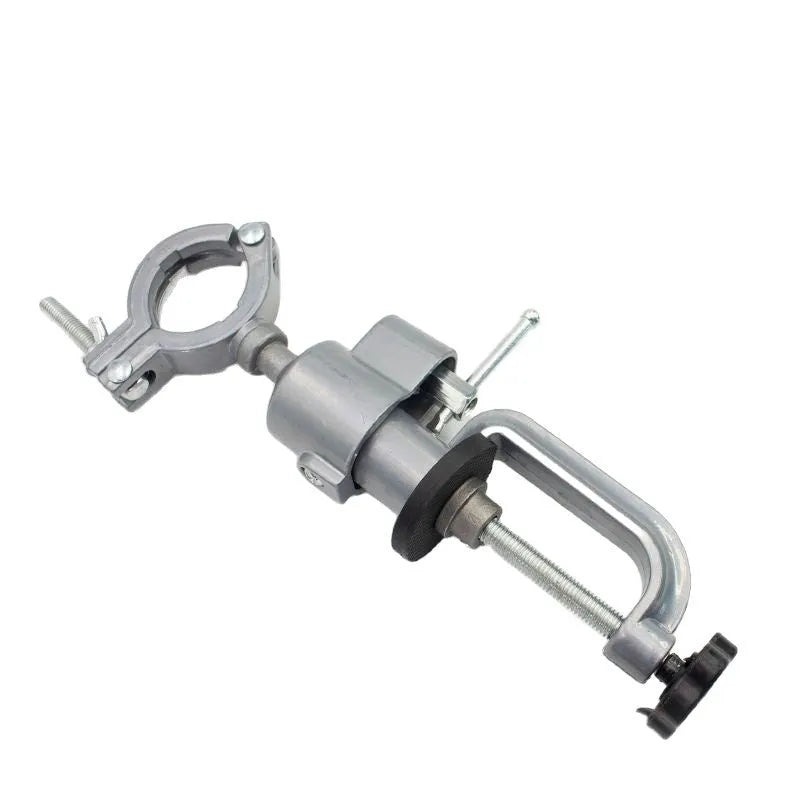 Small flat 360-degree rotating clamp-on bench vise made of tungsten steel on a workbench