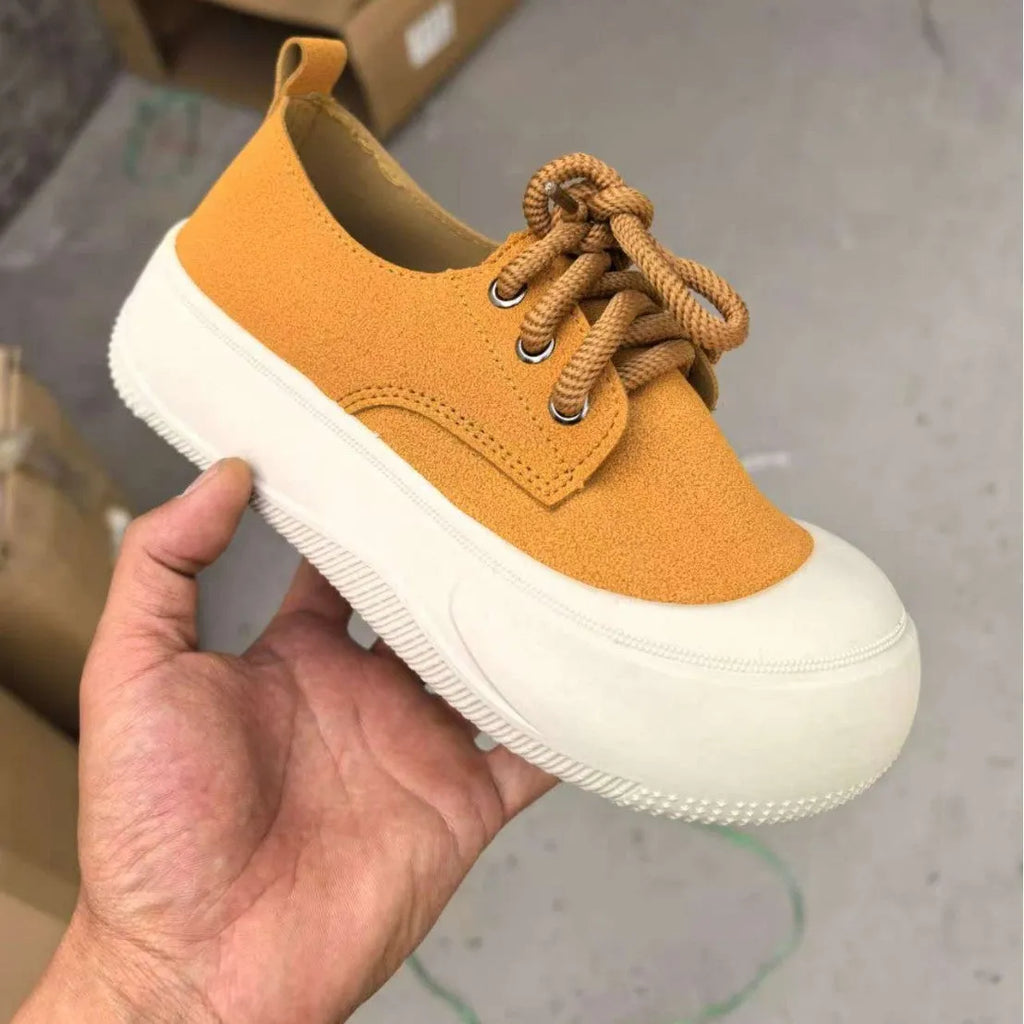 Women's camel suede platform loafers with round toe and front lace-up on a flat rubber sole.