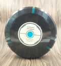 AC household automatic sweeping robot in black on a wooden floor.