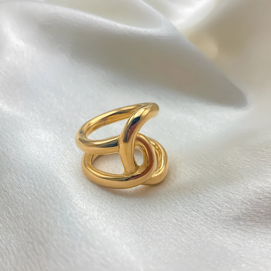 Women's stainless steel adjustable ring with knotted geometric U-shape design in gold or steel colour.
