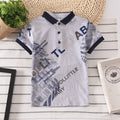 Boy's solid colour cotton short sleeve shirt with lapel collar on a hanger.