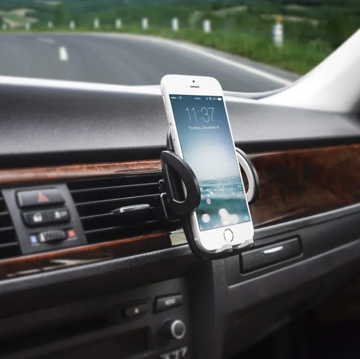 Black plastic car air vent mobile phone holder mounted on vehicle dashboard