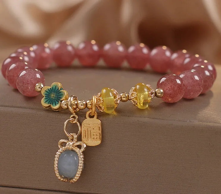 Natural Strawberry Quartz beaded bracelet with rhinestone accents on red alloy base