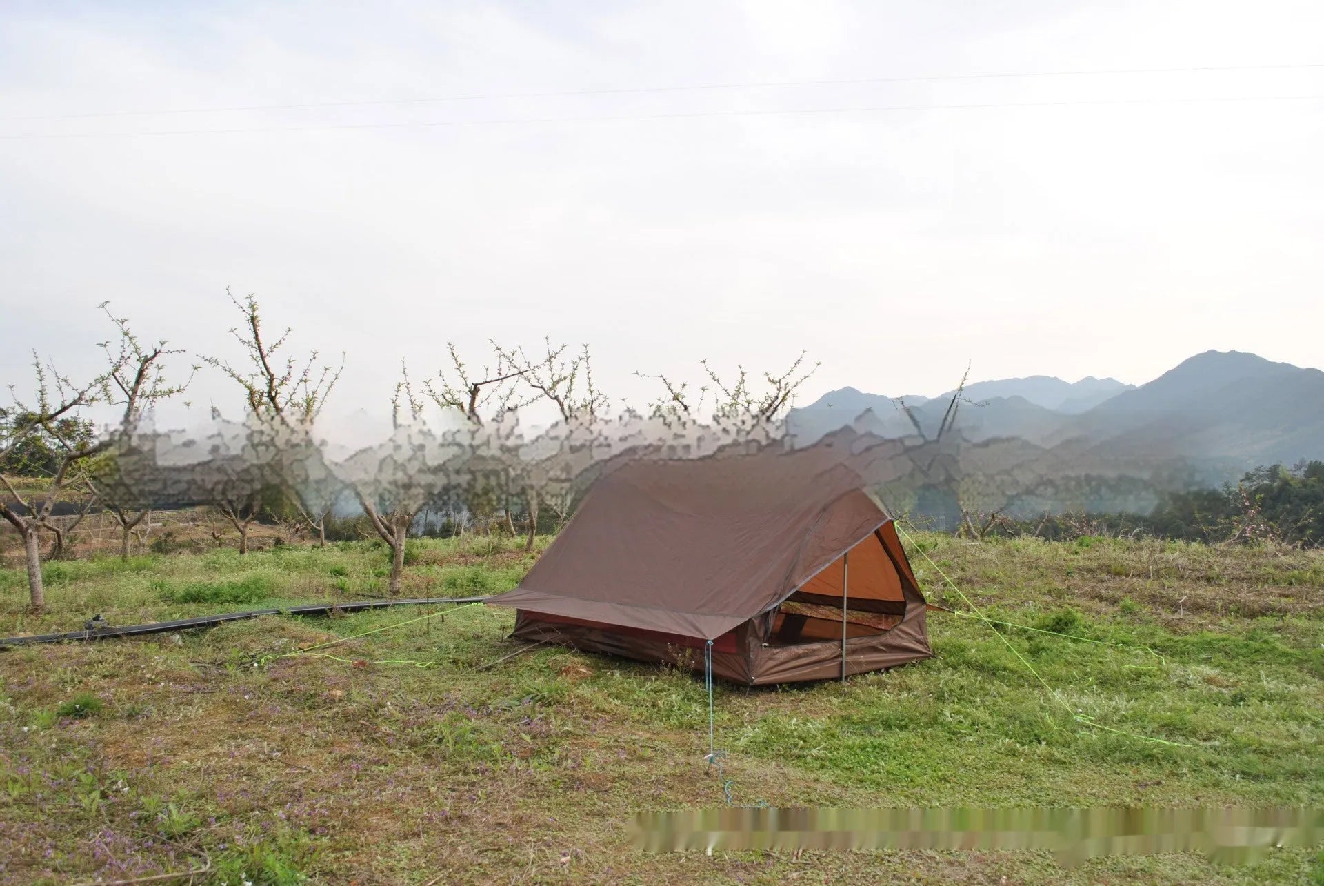 Brown A-line trekking tent pitched using hiking poles with dimensions 210x150x110cm