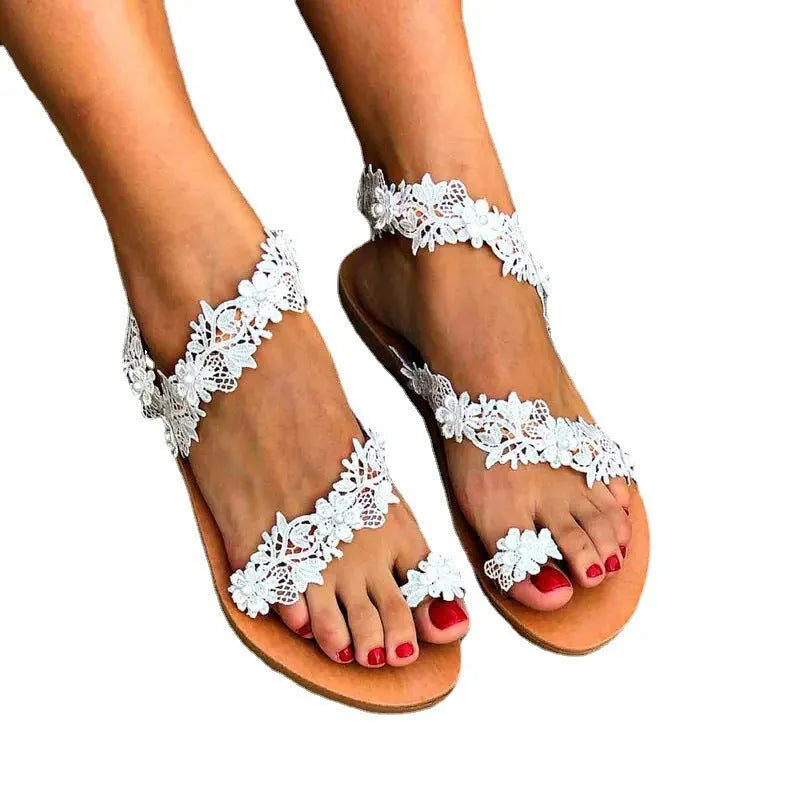 White plus size flat sandals with rhinestone flower patterns and slip-on sleeve design