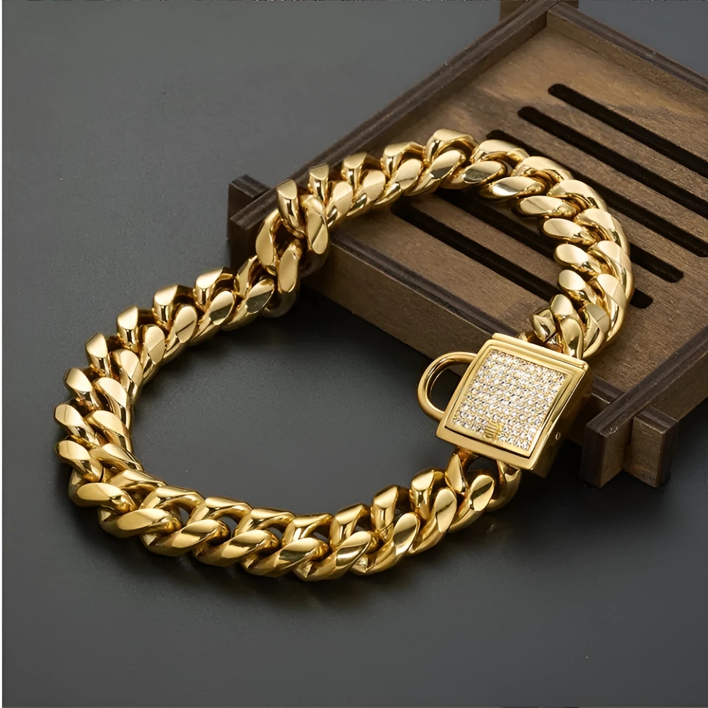 Gold titanium steel pet dog collar with encryption chain buckle lying on surface