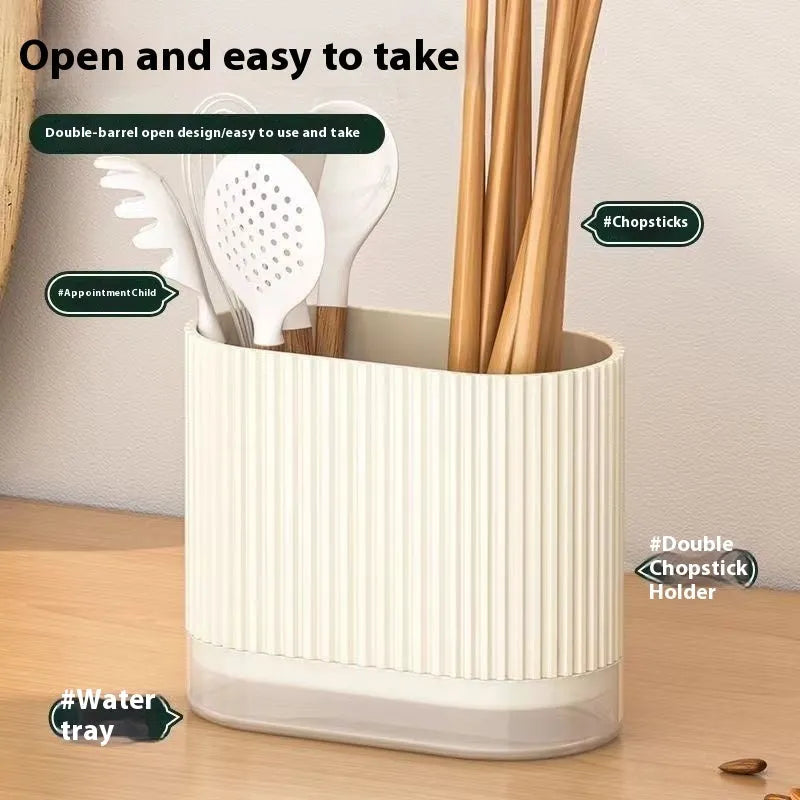 Plastic wall-mounted chopstick holder in beige with drainage holes, containing chopsticks and spoon