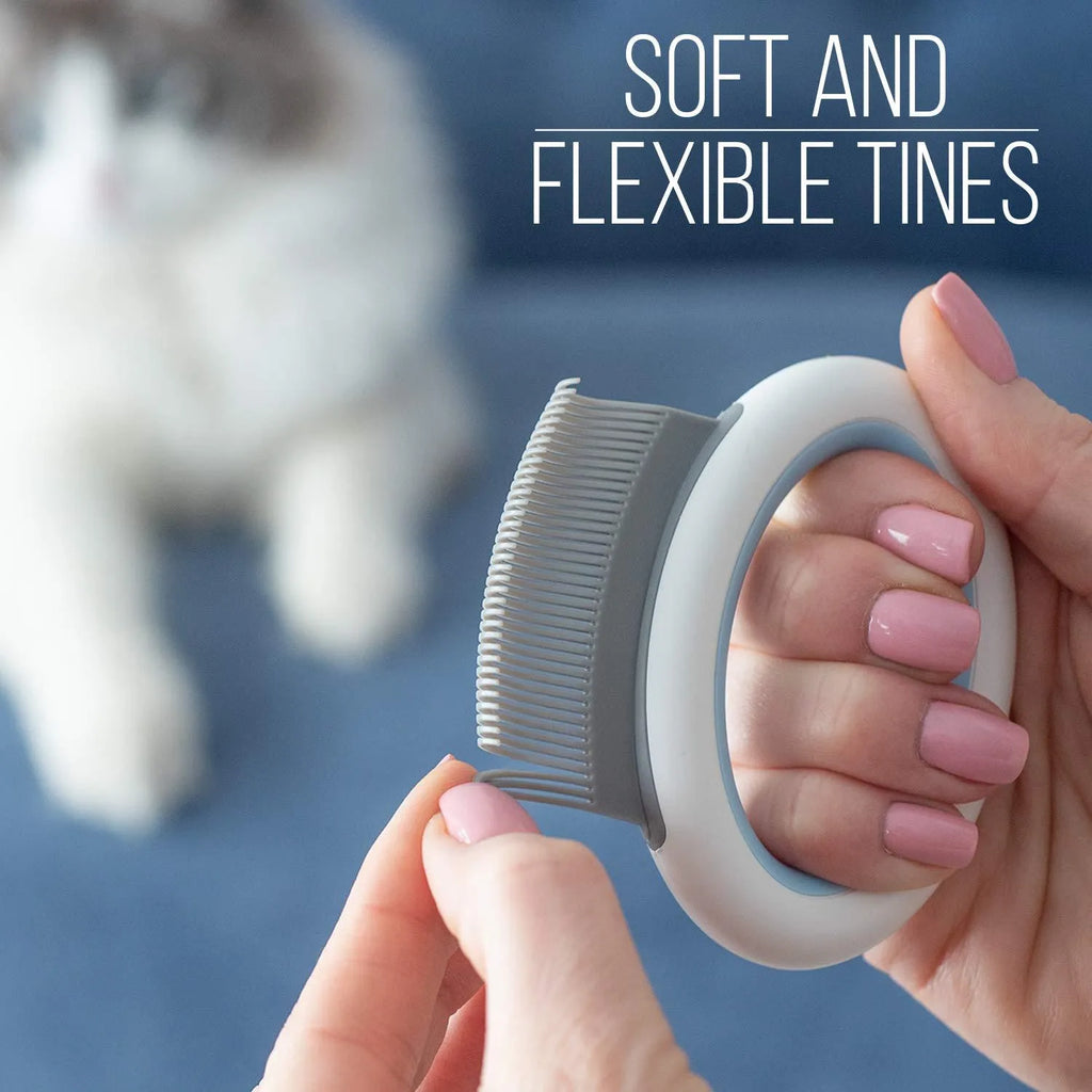 Blue plastic pet grooming comb with soft teeth and an ergonomic handle on a white background.