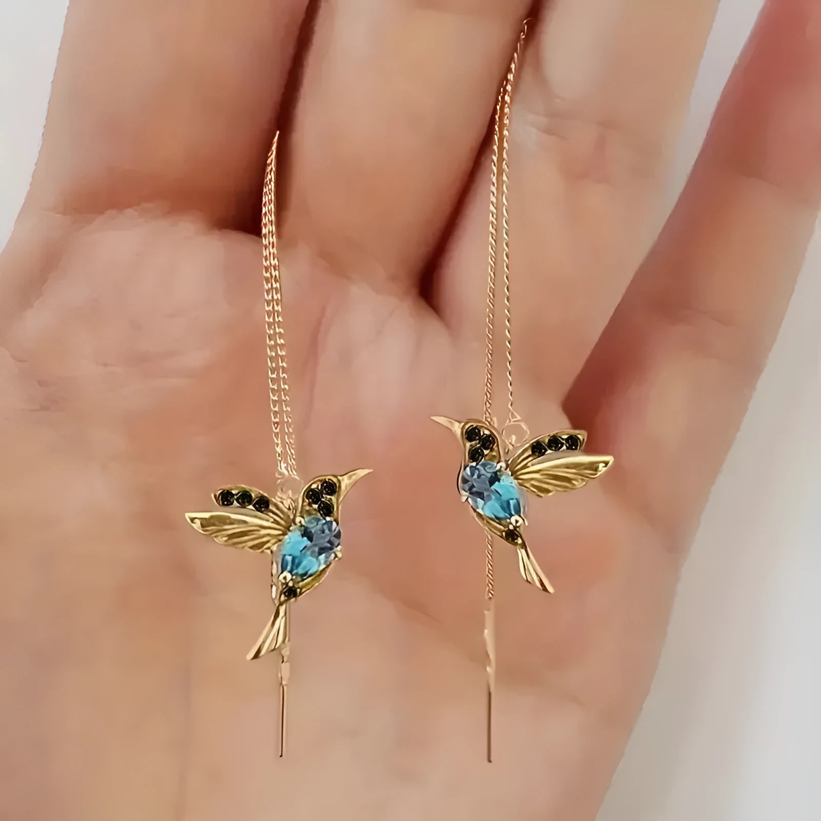Long style women's earrings with a hanging bird design featuring mixed zirconium wings.