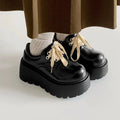 Matte black women's platform shoes with lace-up closure and 6-8cm block heel