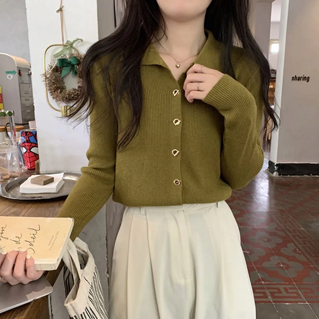 A loose-fitting, long-sleeved beige knitted cardigan for women, made from viscose fibre.