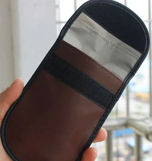 Black microfiber faraday bag for blocking car key and phone signals, measuring 13.5 by 9.5 centimetres.