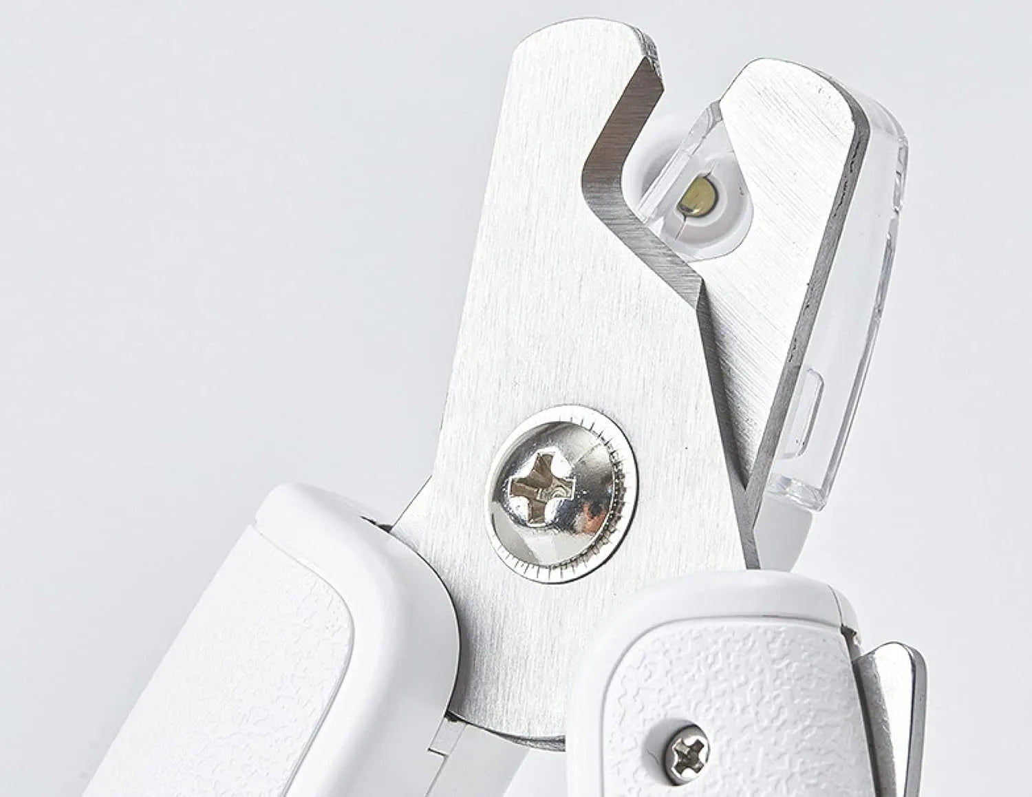 White pet nail clippers with LED light, transparent guard, and a separate nail file on a plain background.