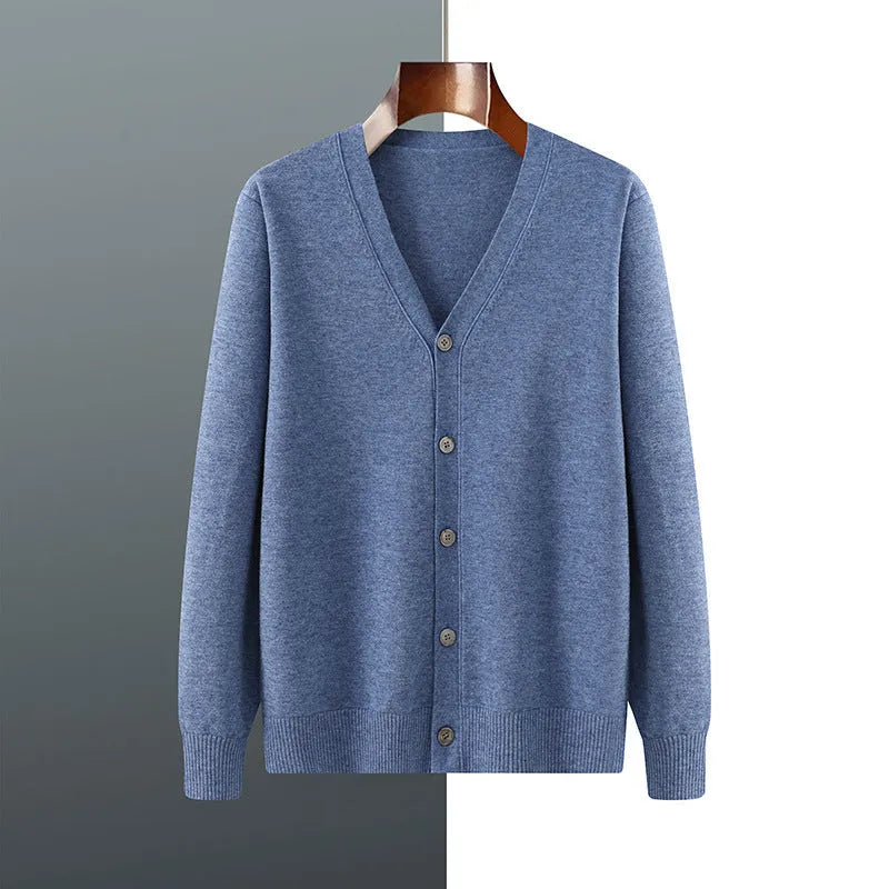 Man wearing a beige loose-fit V-neck Andy velvet knitted cardigan coat with long sleeves.