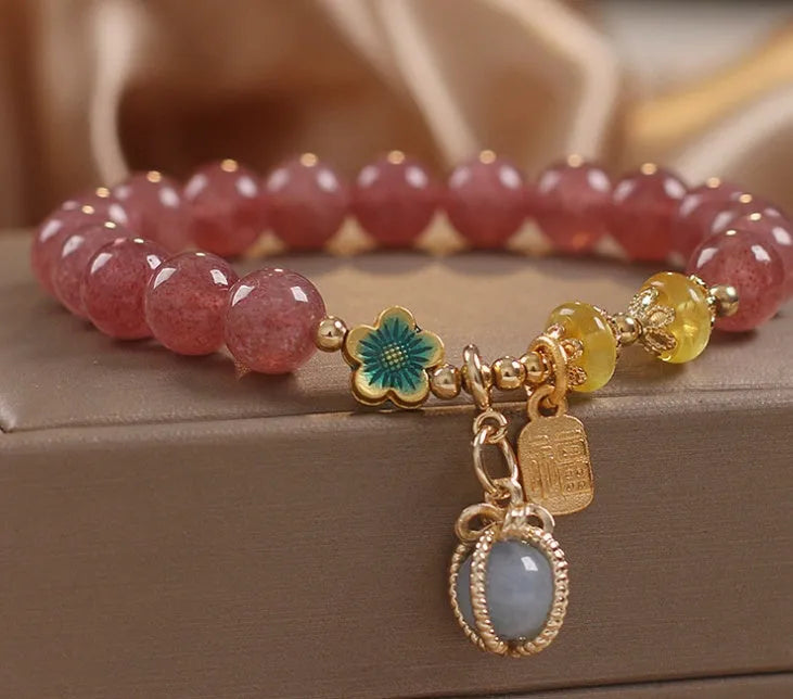 Natural Strawberry Quartz beaded bracelet with rhinestone accents on red alloy base