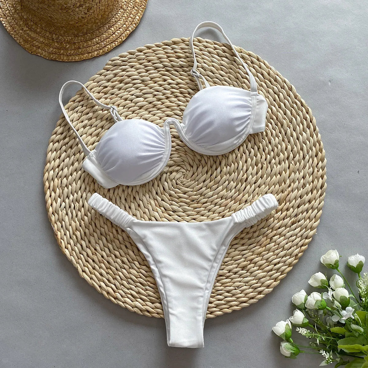 Women's black underwire bikini swimsuit with split briefs, shown on a model.