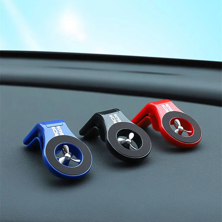Black magnetic car phone holder attached to car air vent with phone mounted and adjustable rotation