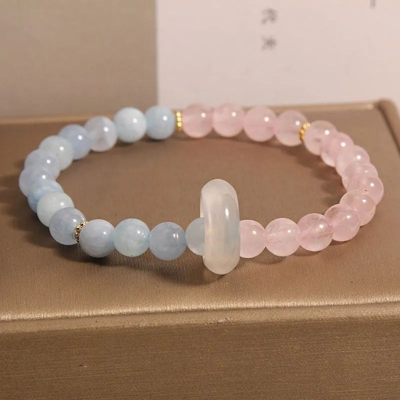 Women's aquamarine crystal bracelet with round geometric beads in mixed materials including natural pink crystal and imitation pearl