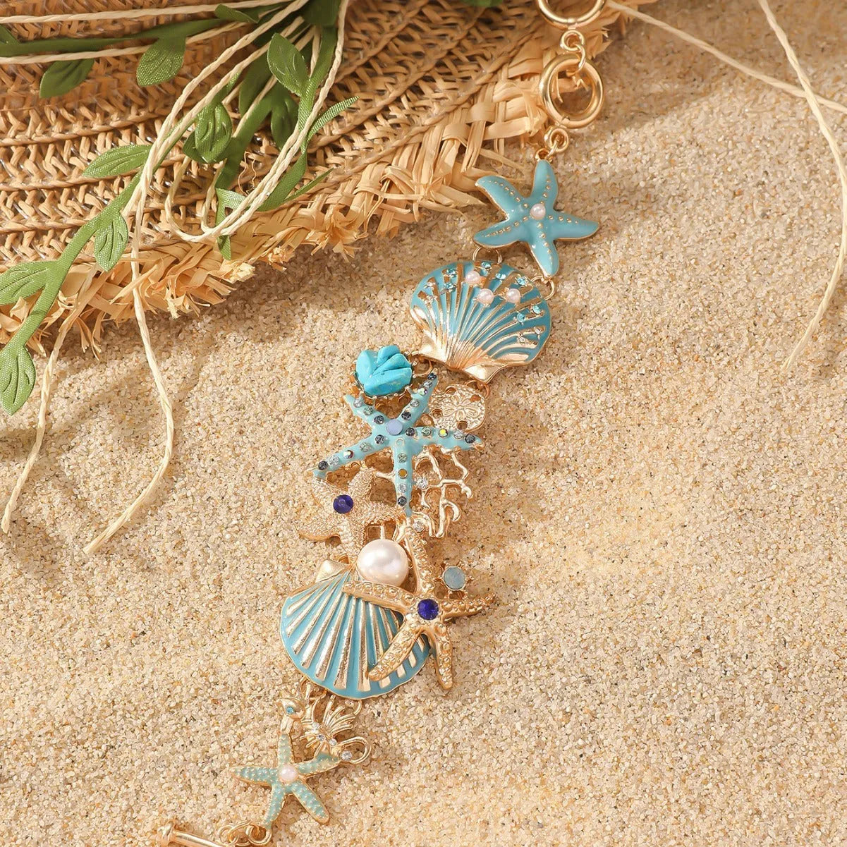 Women's alloy bracelet with rhinestone boat anchor charm and starfish detail in turquoise, red, or blue.