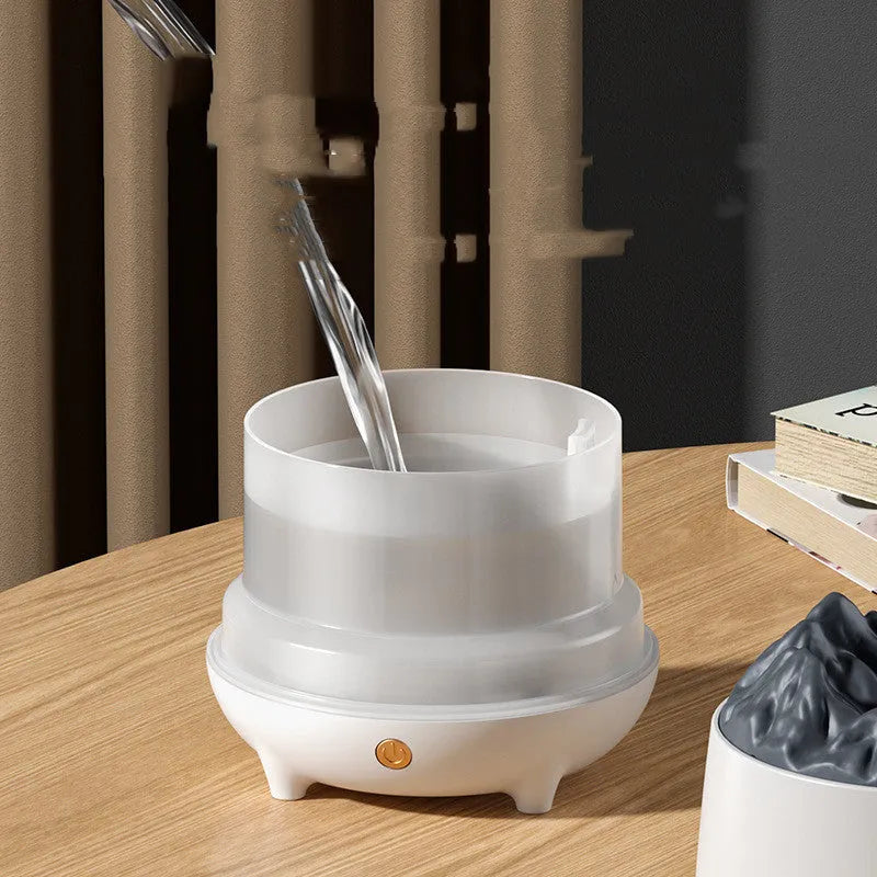 White volcano-shaped ultrasonic humidifier with USB cable on wooden surface