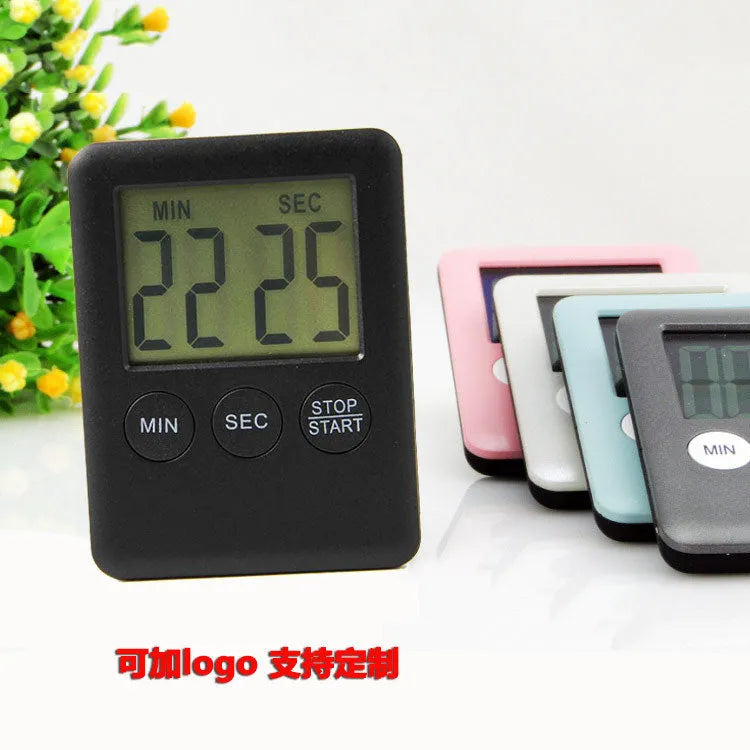 Square white digital kitchen timer with LCD display on magnetic refrigerator door