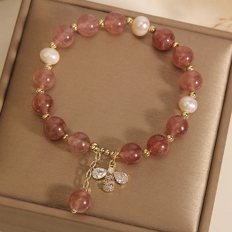 Pink strawberry quartz and white freshwater pearl bracelet with bee charm and zircon accents