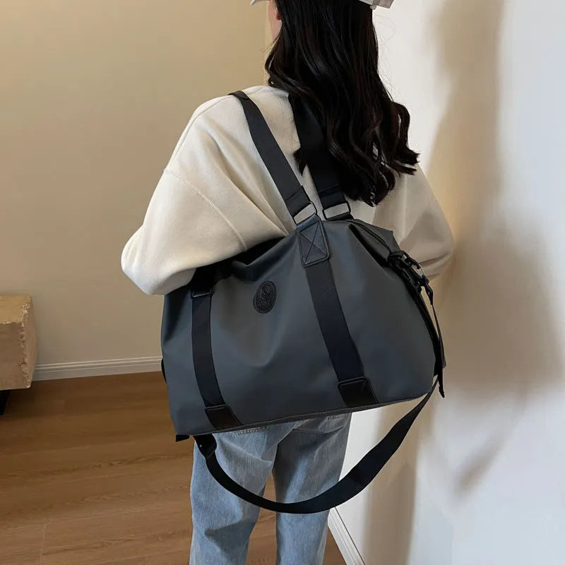 Oxford cloth travel bag in black with 36-55 litre capacity showing breathable back panel and organisational compartments