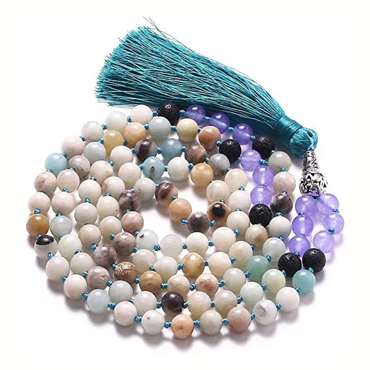 Long beaded agate and amethyst tassel necklace with blue grain stone and lapis lazuli on a geometric design.