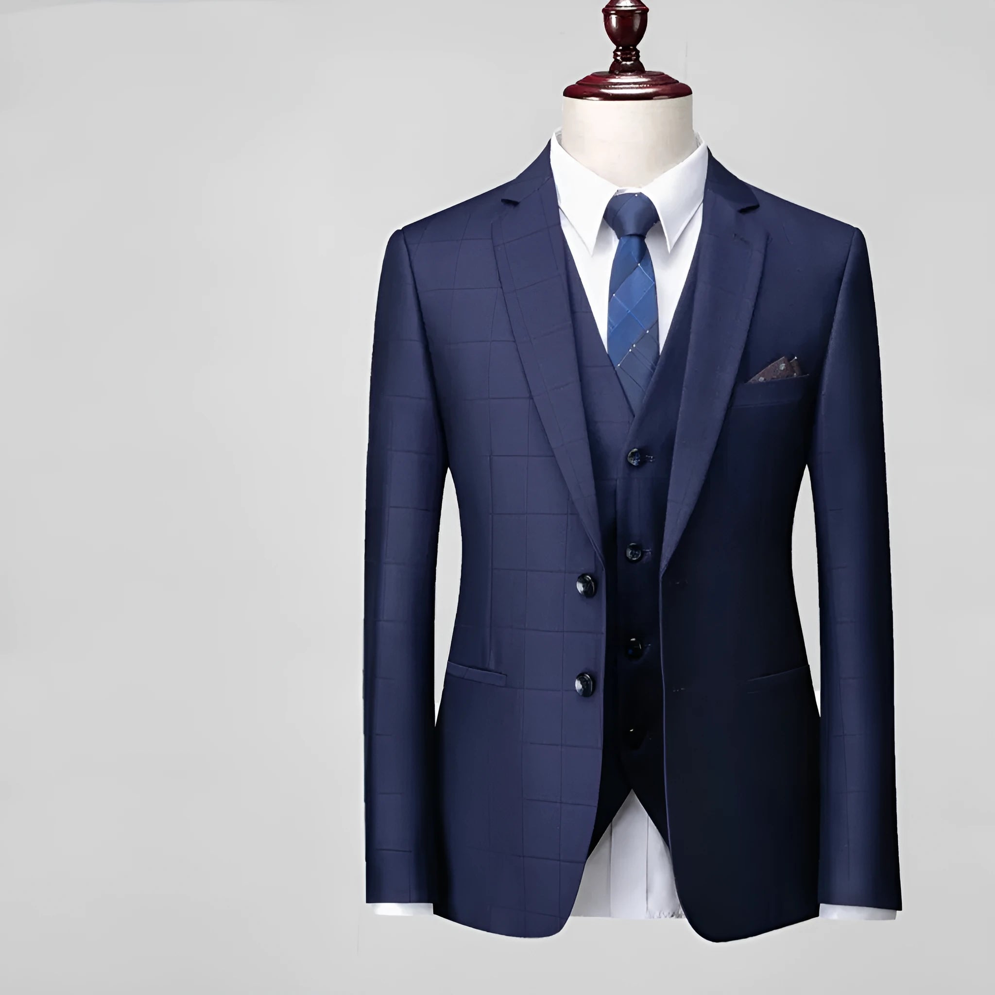 Men's navy blue three-piece plaid suit with slim fit design on hanger