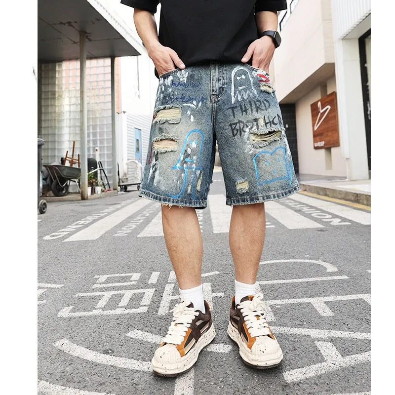 Blue denim shorts for men with ripped detailing and a straight leg cut.