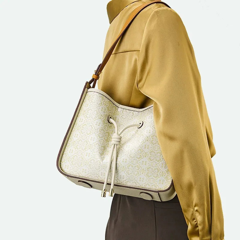 Light luxury genuine leather underarm bag in bucket shape, beige, with three-dimensional outer pocket on front