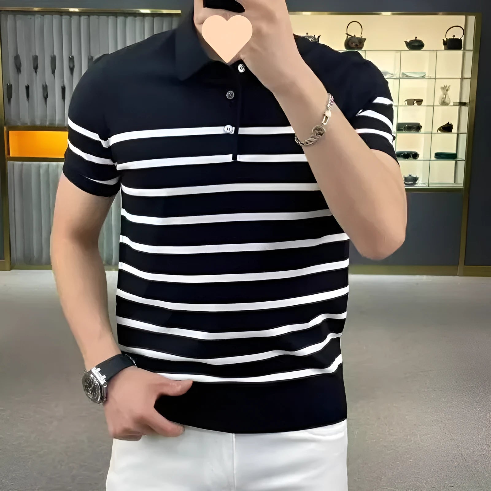 Black and white striped pullover T-shirt laid flat, showing non-iron casual design.