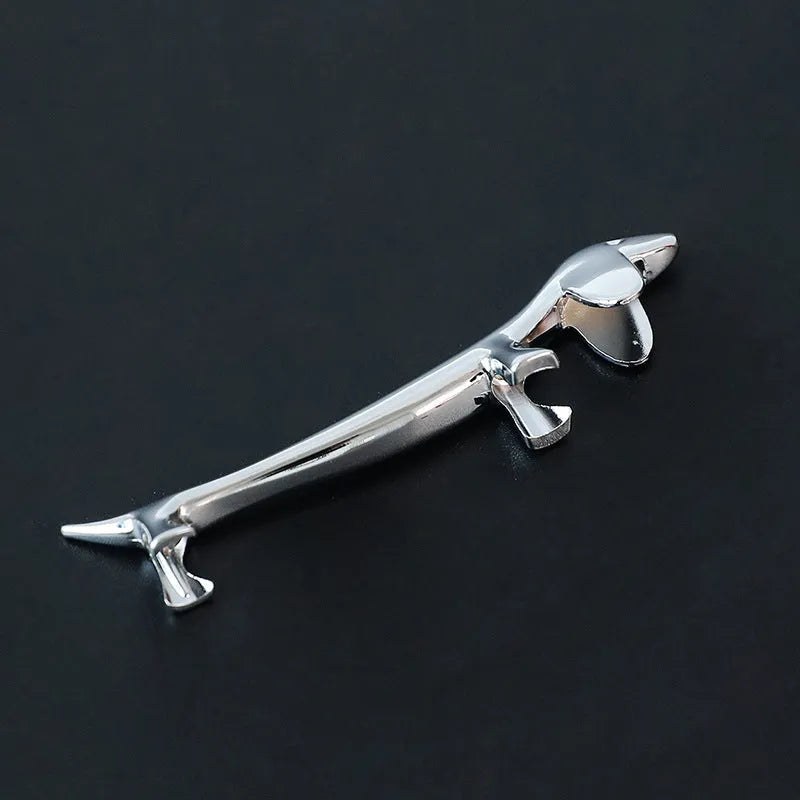 Silver zinc alloy sausage dog chopstick rest knife holder on desk with pen and chopsticks