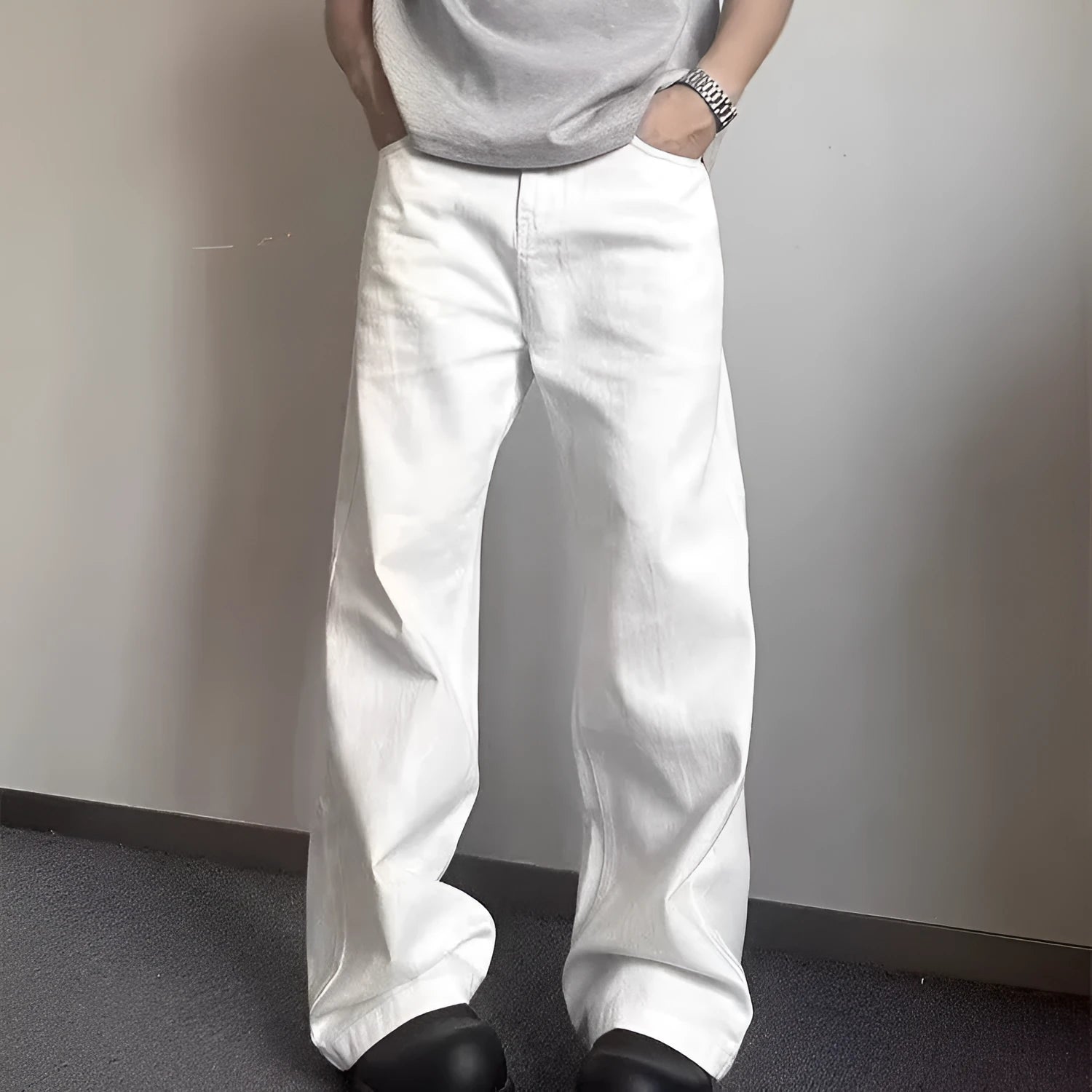 Men's white straight-leg wide fit cotton denim jeans on a neutral background.