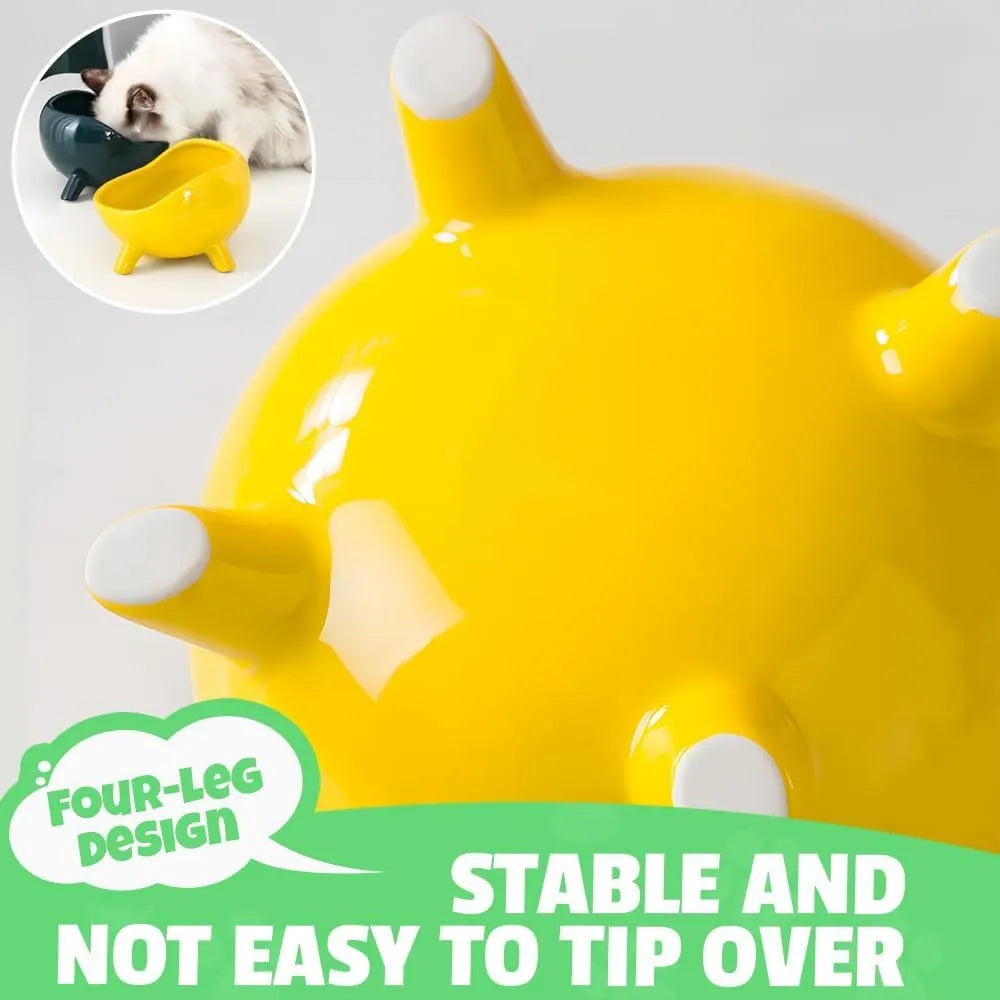 Green ceramic cat food bowl with four legs, wide mouth, and rounded arc shape on a light floor