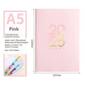 A5 2025 daily schedule book with faux leather cover in blue colour, open to show lined pages and thread binding.