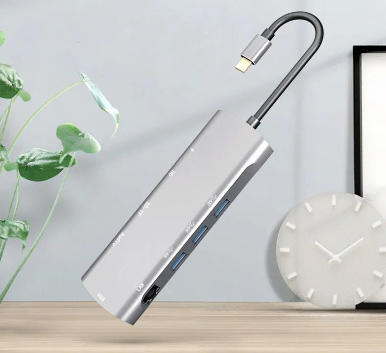 Grey USB-C docking station with aluminium alloy shell showing HDMI, VGA and USB ports